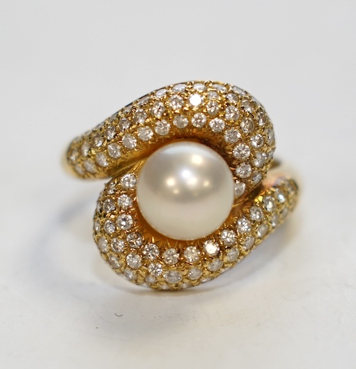 A modern 18ct gold, single stone cultured pearl and diamond chip cluster set dress ring, size M, gross weight 7.5 grams. Condition - good